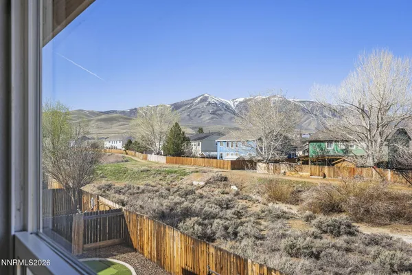a view of a house with a yard covered in snow