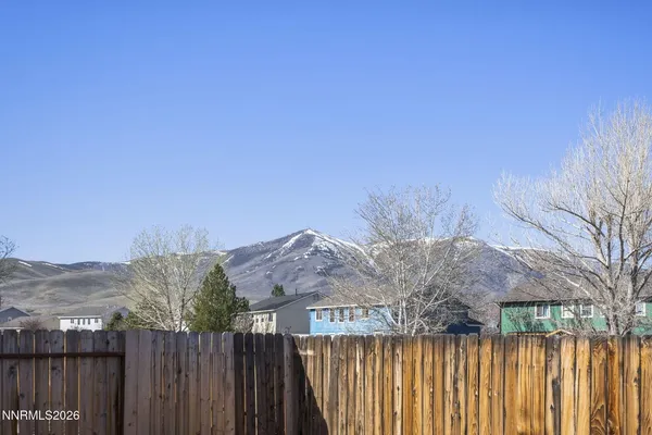 a view of a wooden fence next to a mountain