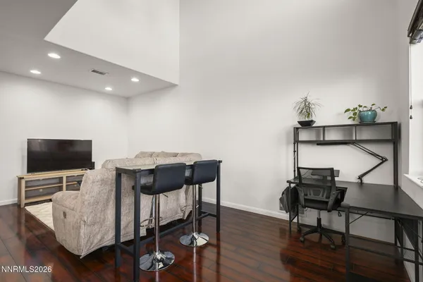 a view of a workspace with furniture and wooden floor