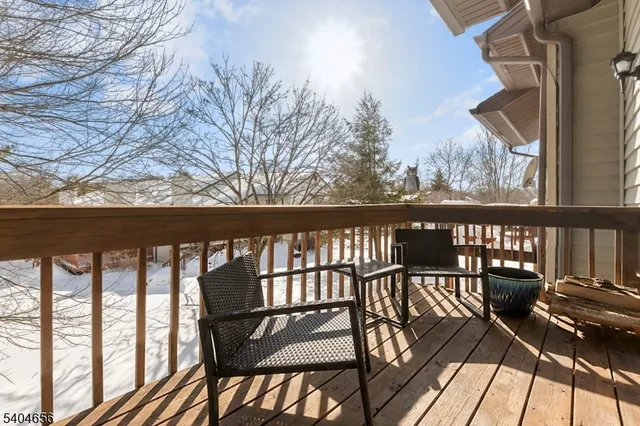 a view of a chairs and table in the balcony