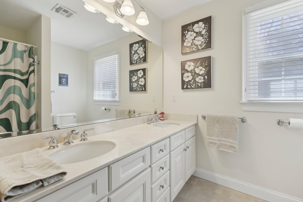 211 Red Acre Road Stow, MA 01775 - Photo 19 of 35 a bathroom with double vanity sink a mirror and a shower