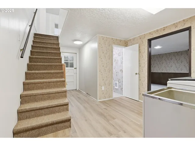 a view of kitchen with utility room and wooden floor