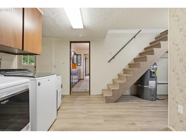 a bathroom with a sink mirror and shower