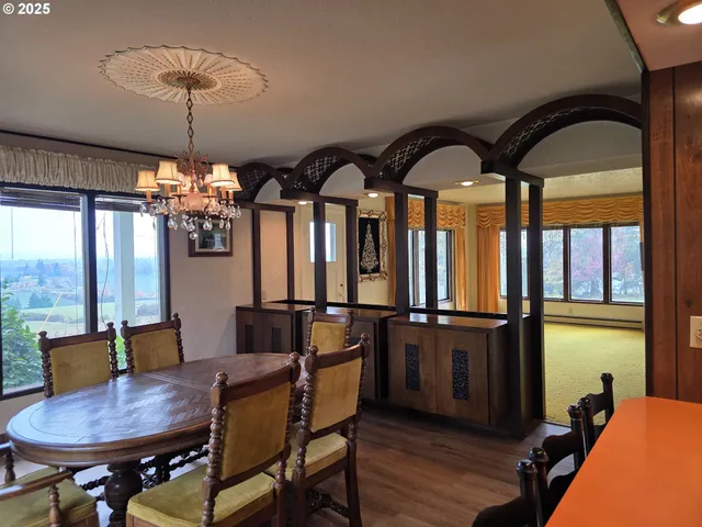 a dining room with furniture and chandelier