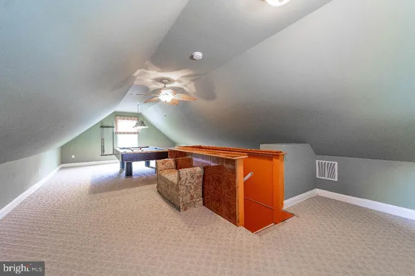 wooden floor with furniture and chandelier in it