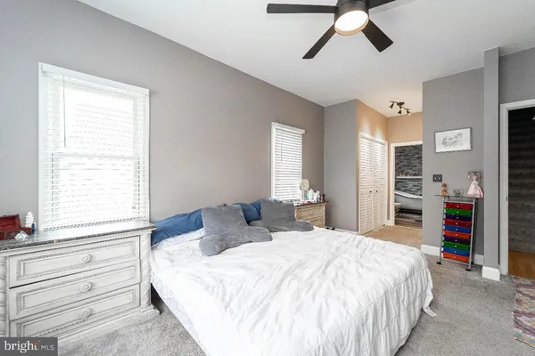 a bedroom with a bed and a large window