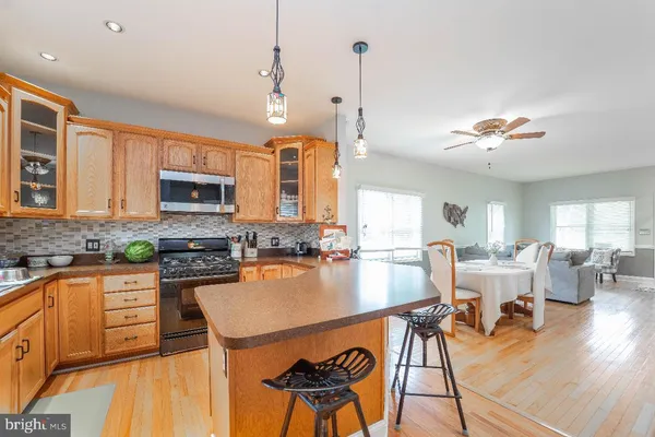 a kitchen with a dining table chairs stove and sink