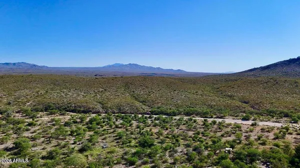 a view of mountain with lake in background