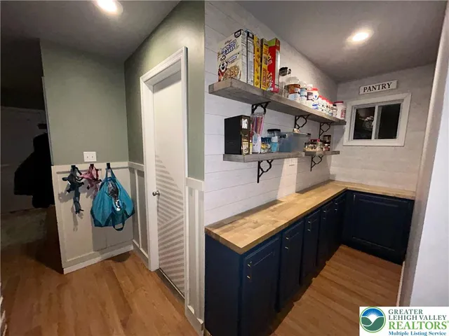 a spacious bedroom with a bed and a mirror on dresser