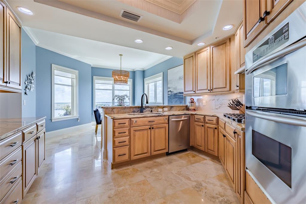 130 Riviera Dunes Way, Unit 802 Palmetto, FL 34221 - Photo 11 of 56 a kitchen with granite countertop a sink stove and refrigerator