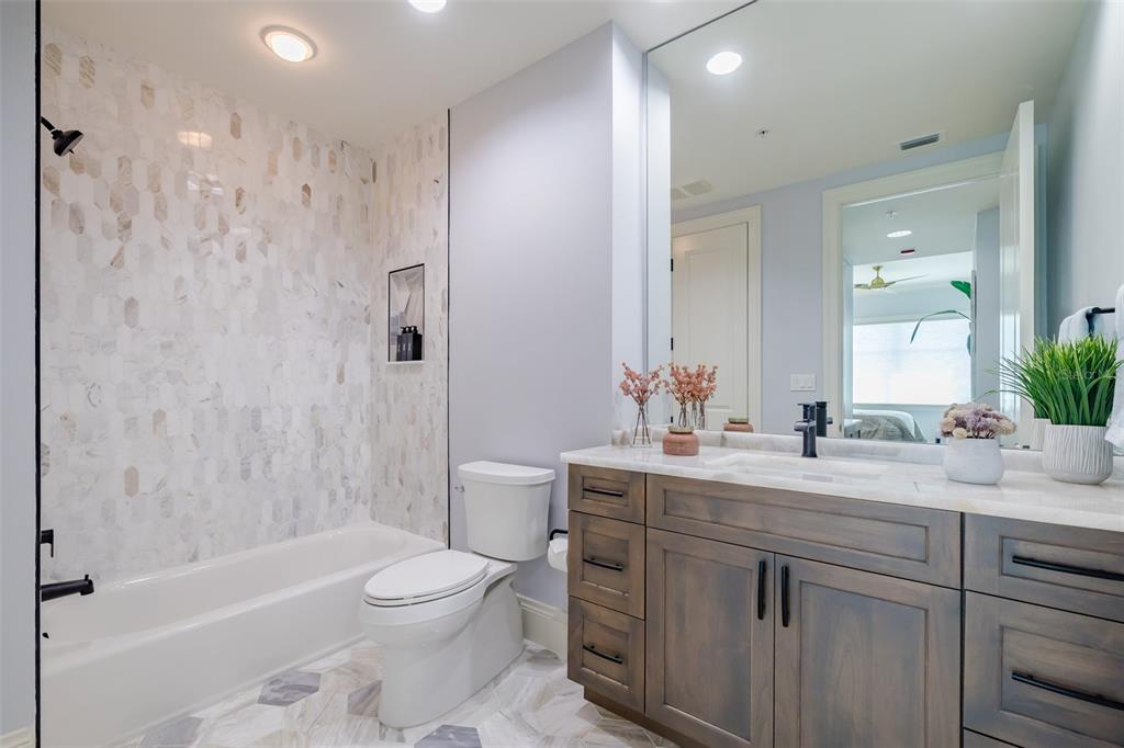 130 Riviera Dunes Way, Unit 802 Palmetto, FL 34221 - Photo 24 of 56 a bathroom with a sink a toilet and shower
