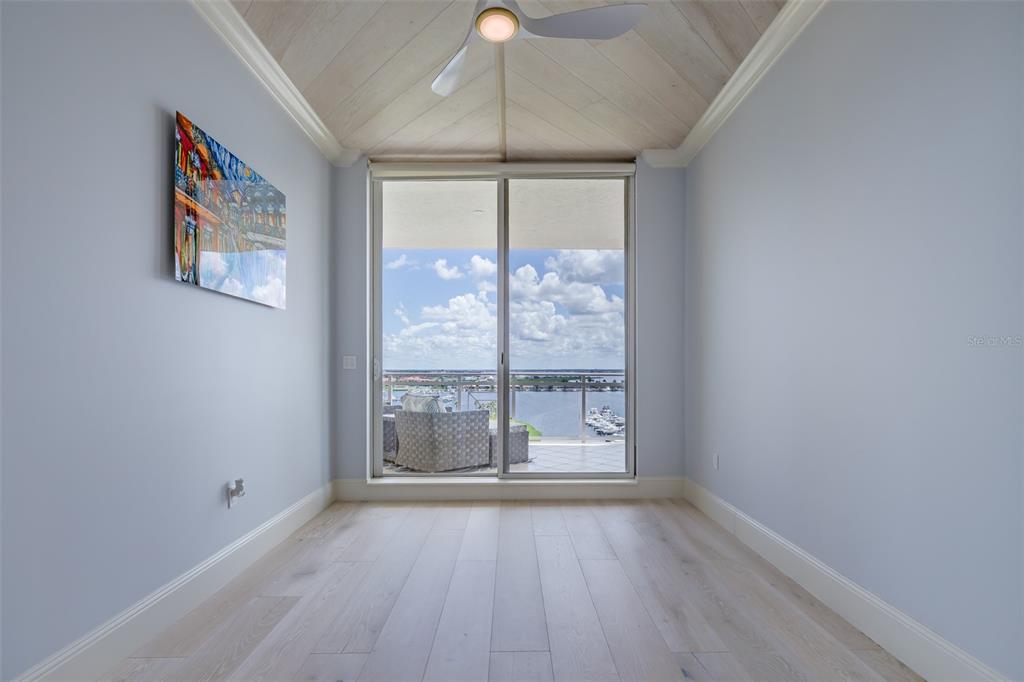 130 Riviera Dunes Way, Unit 802 Palmetto, FL 34221 - Photo 26 of 56 an empty room with wooden floor and windows