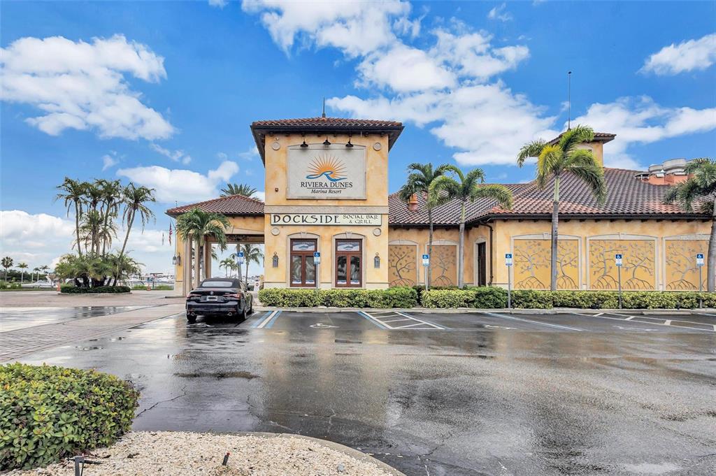 130 Riviera Dunes Way, Unit 802 Palmetto, FL 34221 - Photo 37 of 56 a front view of a building with parking lot