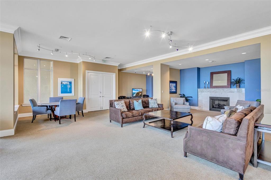 130 Riviera Dunes Way, Unit 802 Palmetto, FL 34221 - Photo 38 of 56 a living room with furniture and a fireplace