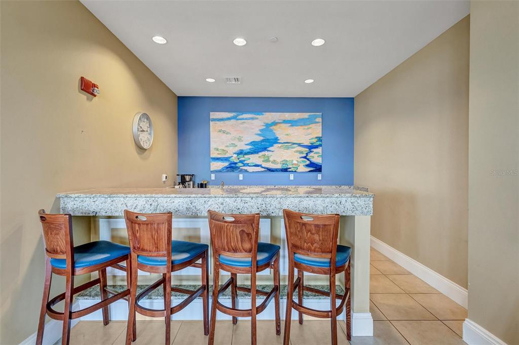 130 Riviera Dunes Way, Unit 802 Palmetto, FL 34221 - Photo 43 of 56 a view of a dining room with furniture and a rug