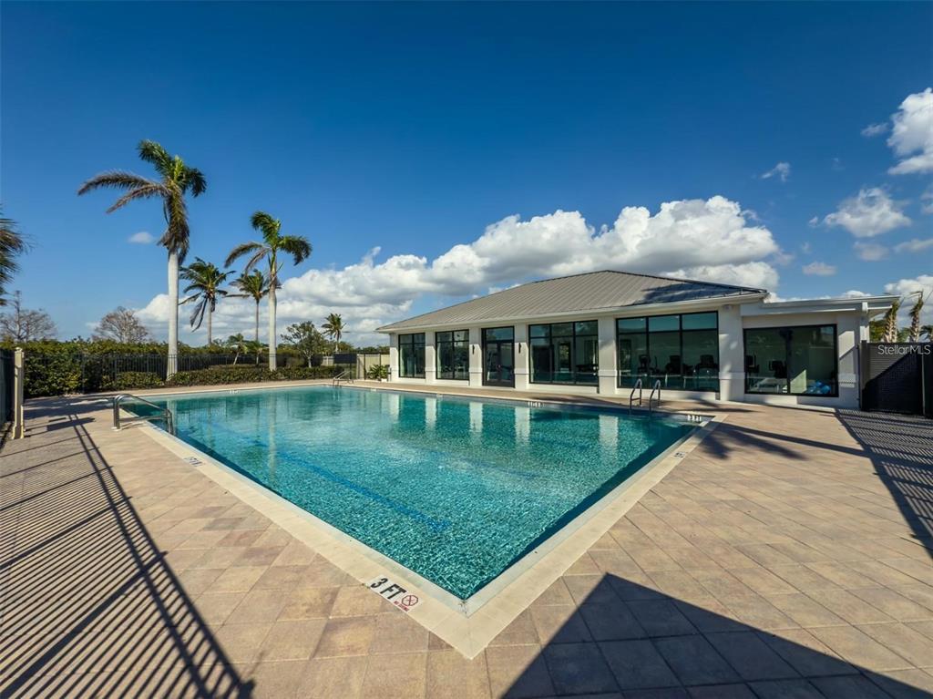 130 Riviera Dunes Way, Unit 802 Palmetto, FL 34221 - Photo 46 of 56 a view of swimming pool with a garden