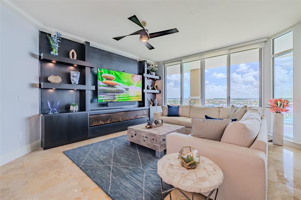 130 Riviera Dunes Way, Unit 802 Palmetto, FL 34221 - Photo 6 of 56 a living room with furniture ceiling fan and a flat screen tv