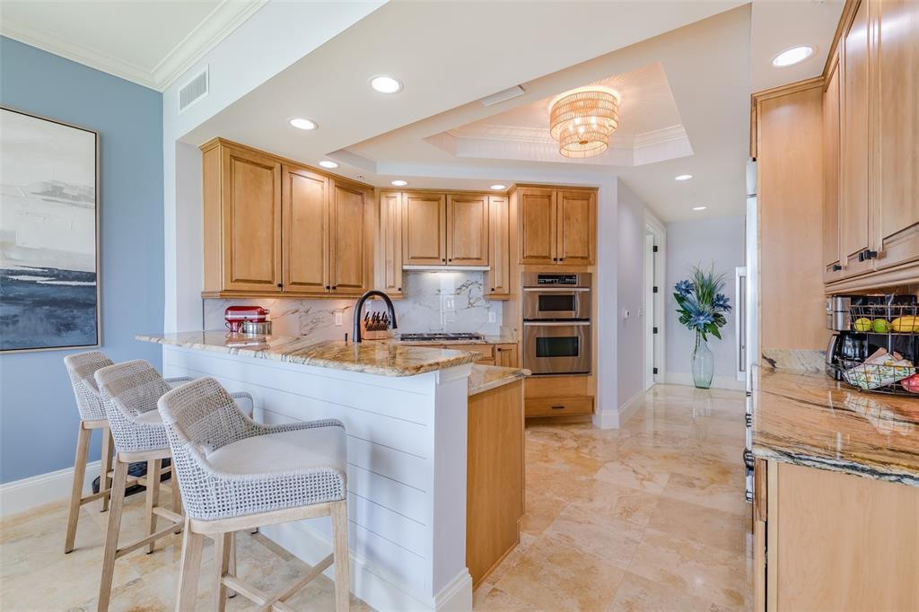 130 Riviera Dunes Way, Unit 802 Palmetto, FL 34221 - Photo 10 of 56 a kitchen with kitchen island granite countertop a sink and counter space