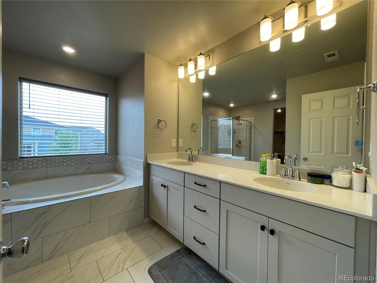 17342 Springfield Drive Parker, CO 80134 - Photo 14 of 35 a bathroom with a large tub sink and double vanity