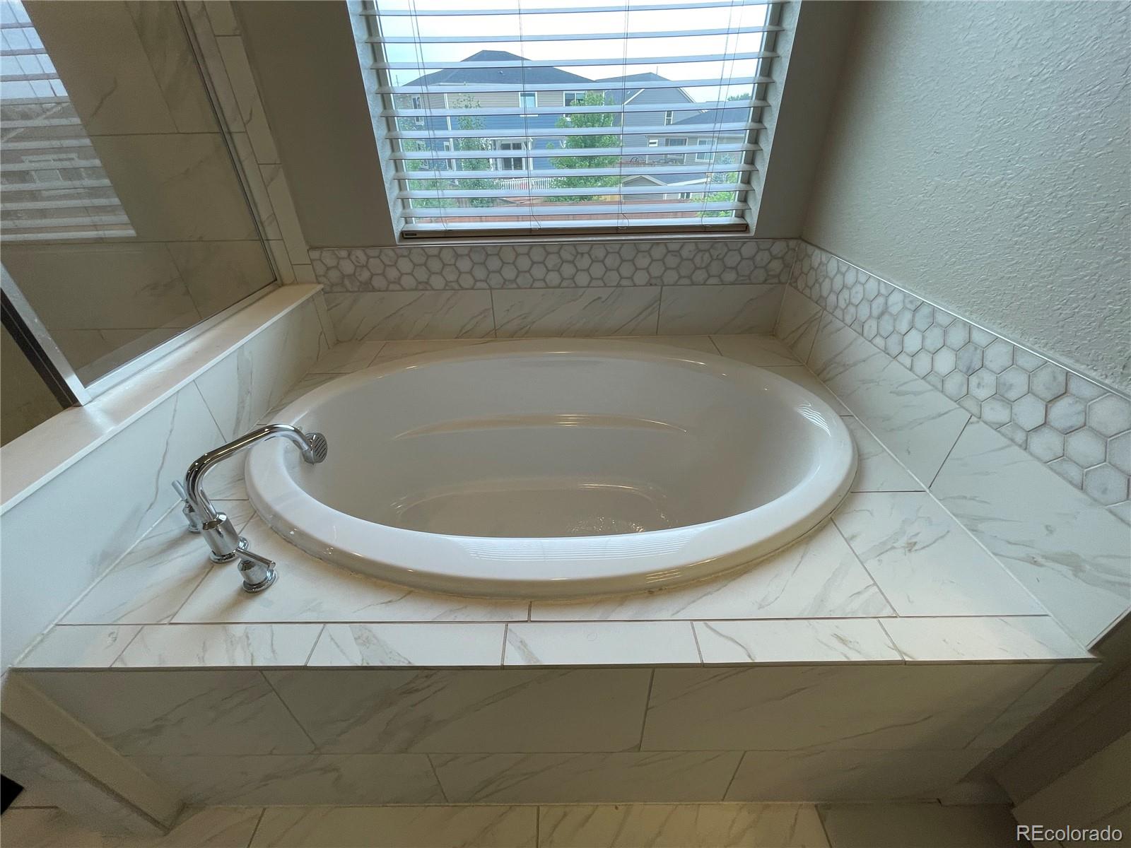 17342 Springfield Drive Parker, CO 80134 - Photo 15 of 35 a bathroom with a bathtub