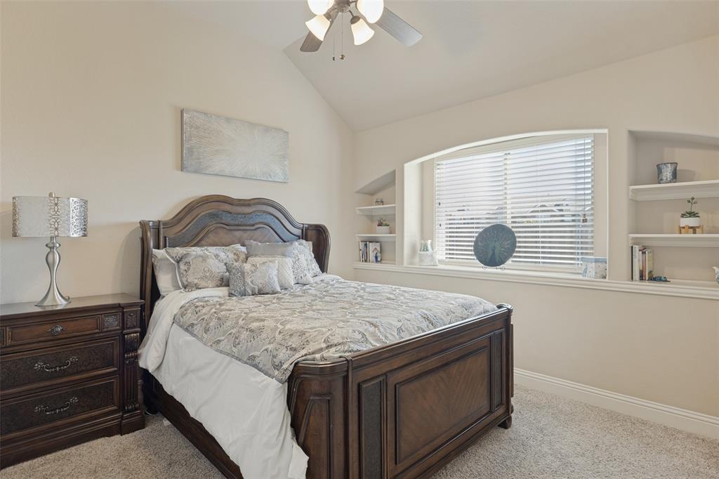 3405 Fletcher Road Heartland, TX 75114 - Photo 19 of 30 Secondary bedroom with shelves on both sides of large window,
