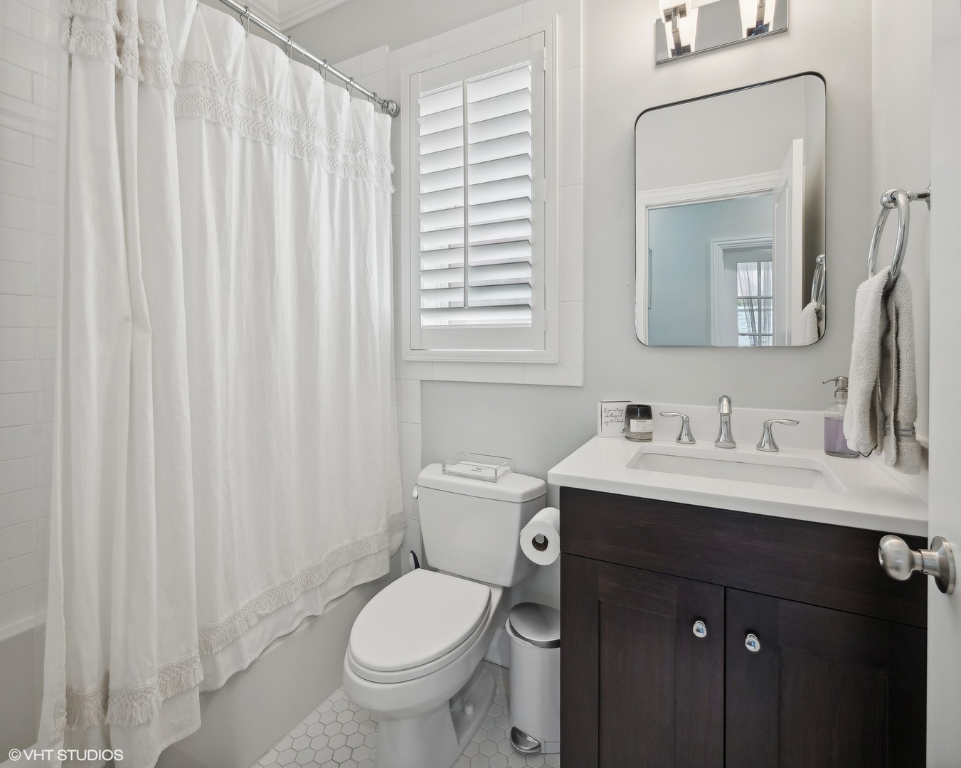 2449 North Racine Avenue, Unit 3 Chicago, IL 60614 - Photo 11 of 18 a bathroom with a granite countertop sink toilet and mirror