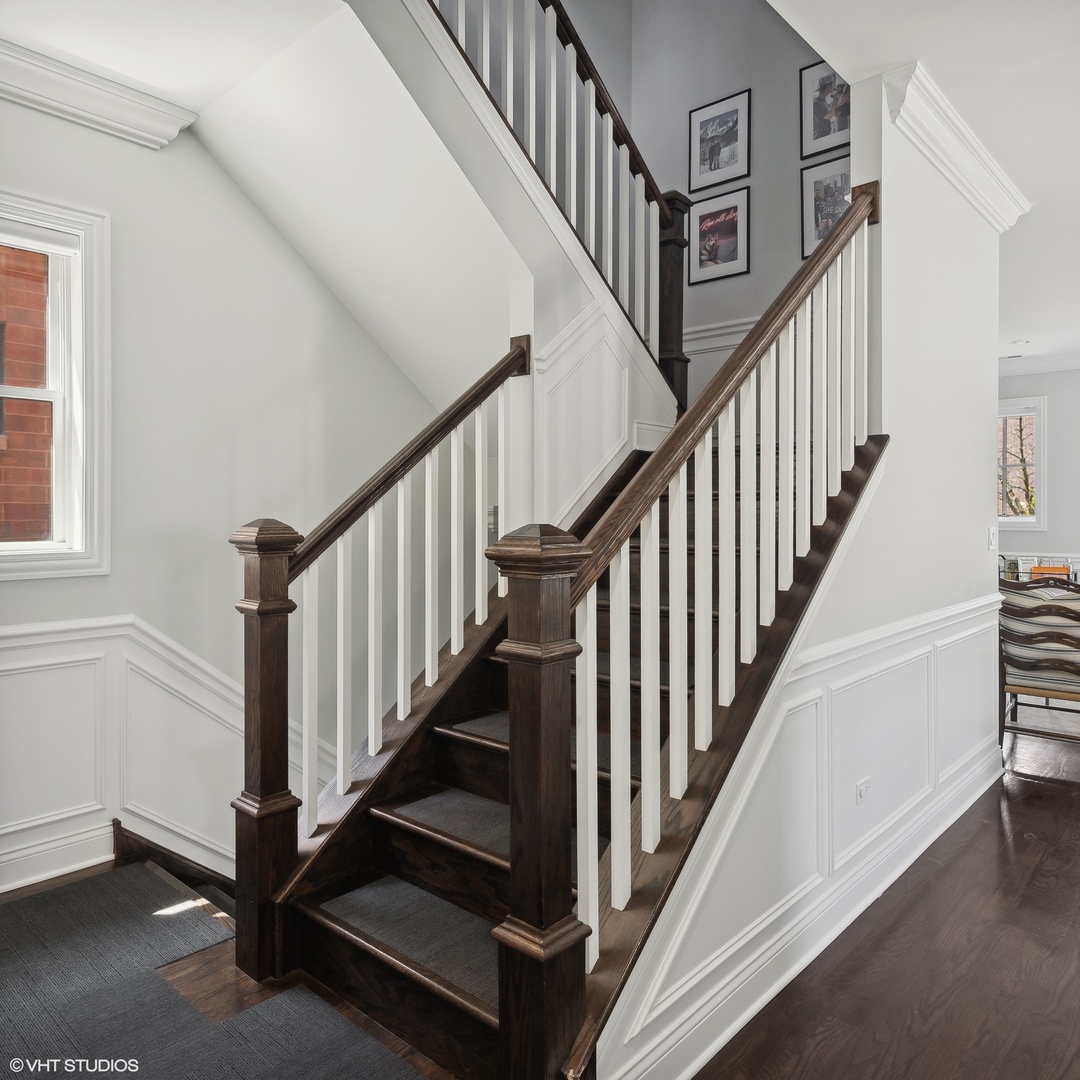 2449 North Racine Avenue, Unit 3 Chicago, IL 60614 - Photo 13 of 18 a view of staircase with wooden floor and a rug