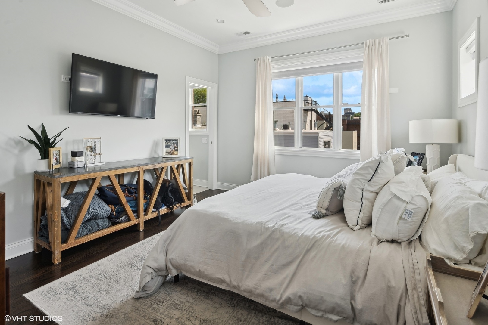 2449 North Racine Avenue, Unit 3 Chicago, IL 60614 - Photo 8 of 18 a bedroom with a bed and a flat screen tv