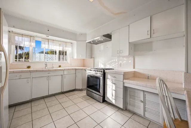a kitchen with a sink stove and cabinets