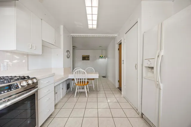 a kitchen with a stove a sink and a refrigerator