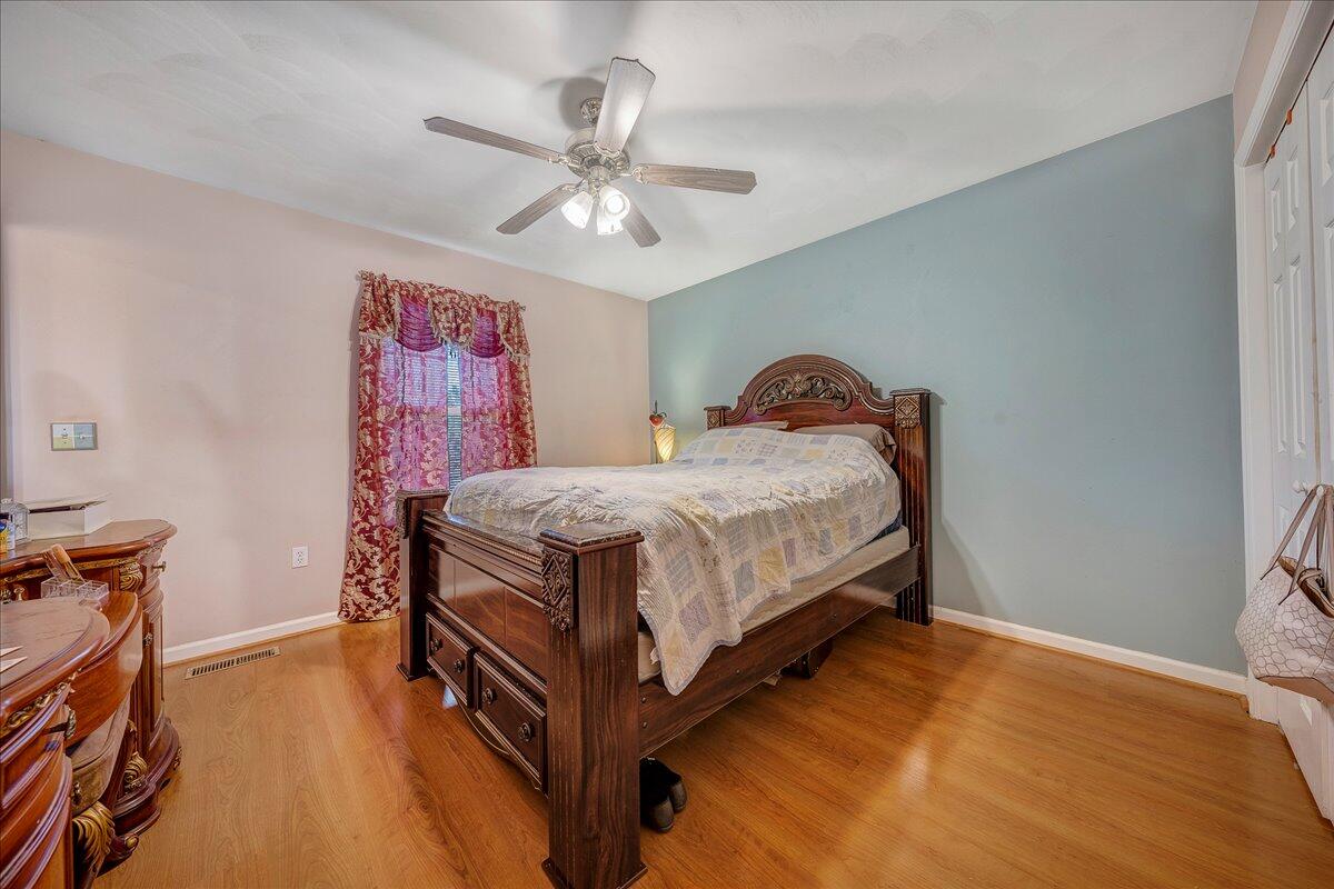 532 Ray Street Roanoke, VA 24019 - Photo 13 of 38 a bedroom with a bed and a chandelier