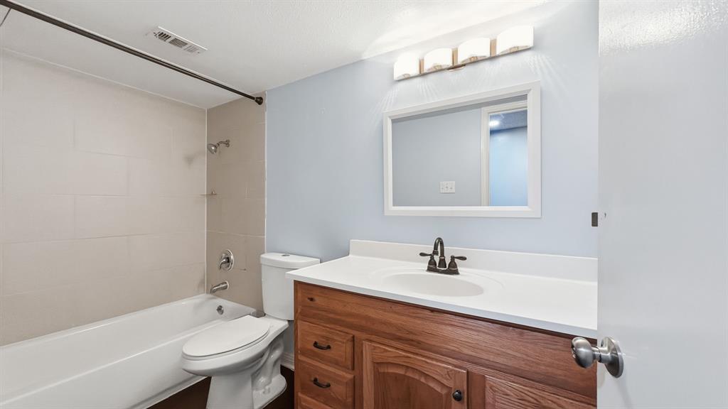 12921 Abrams Road, Unit 208 Dallas, TX 75243 - Photo 10 of 19 White bathtub with light-colored tile surround