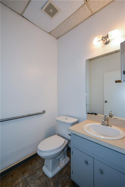 4298 Memorial Drive, Unit D Decatur, GA 30032 - Photo 20 of 26 a bathroom with a sink a toilet and mirror