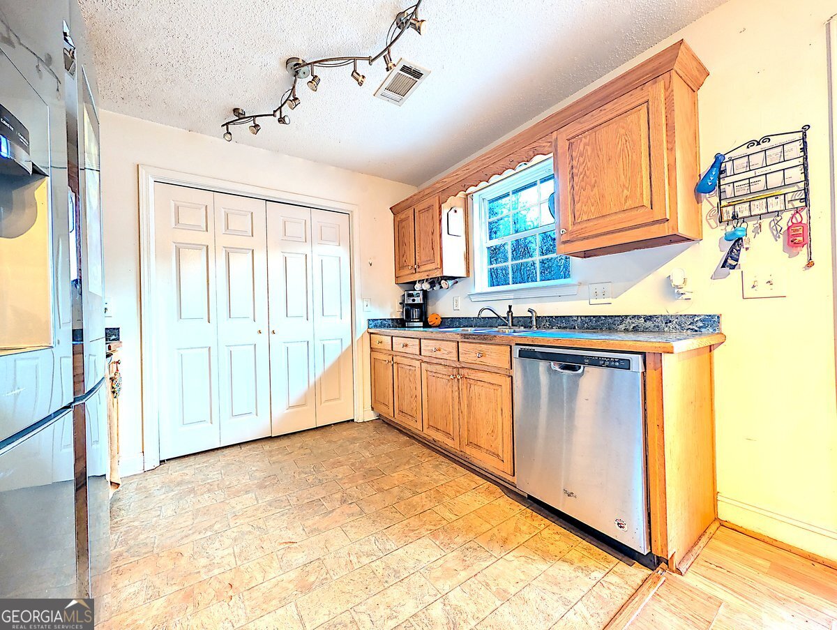 571 Suttles Road Martin, GA 30557 - Photo 2 of 6 a kitchen with stainless steel appliances granite countertop a stove a sink and a refrigerator
