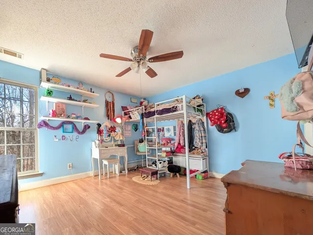 a room with furniture and ceiling fan