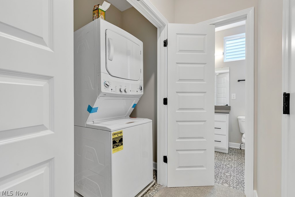 3601 Bailey Avenue Cleveland, OH 44113 - Photo 21 of 22 Laundry room featuring stacked washer / drying machine and light tile flooring