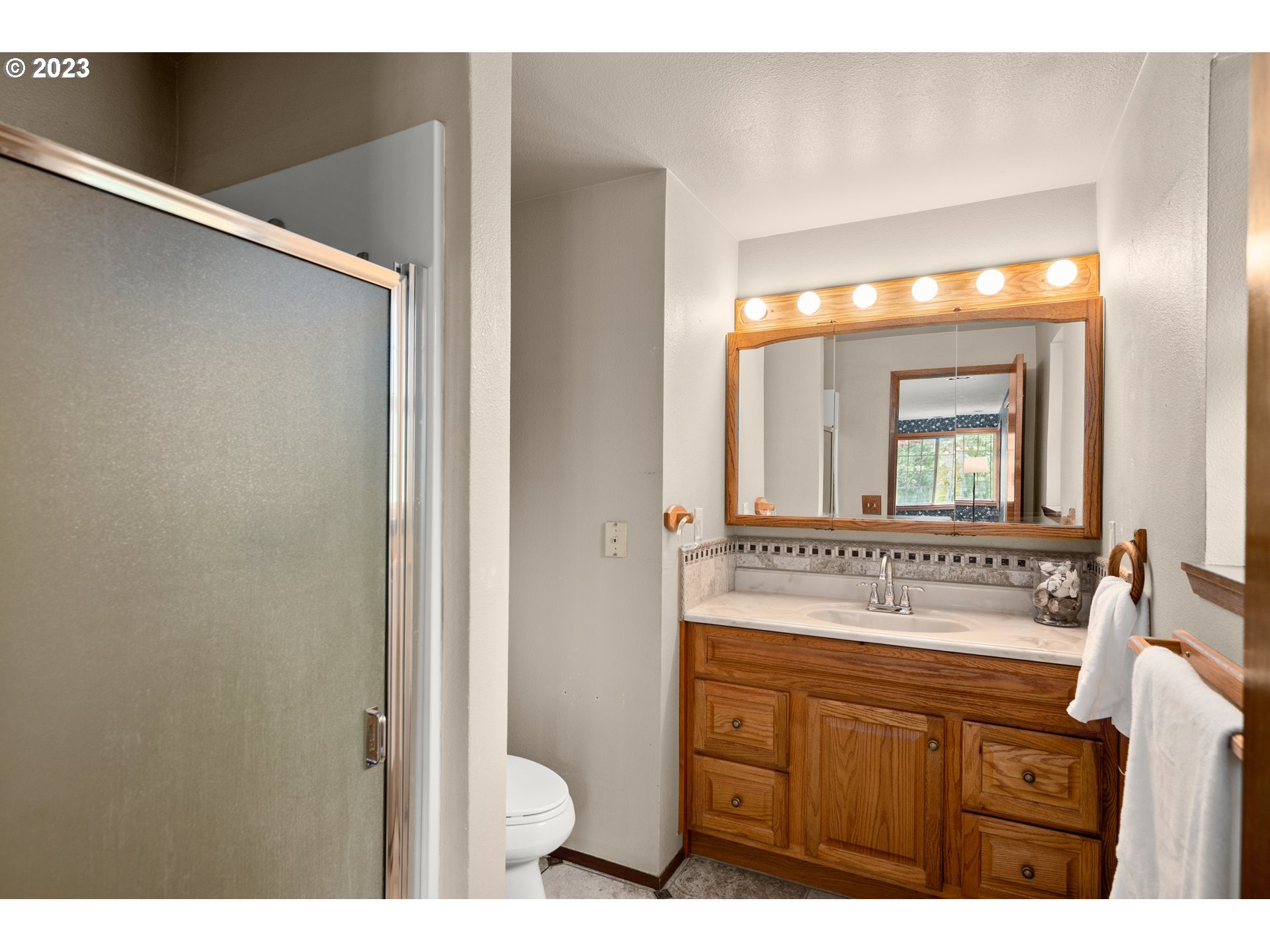 23490 South Beatie Road Oregon City, OR 97045 - Photo 13 of 30 a bathroom with a mirror sink and toilet