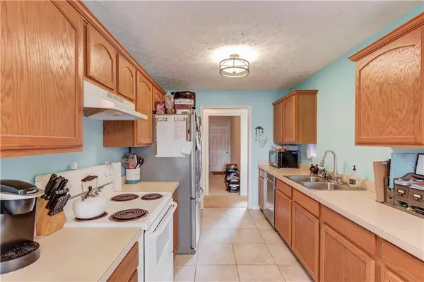 a kitchen with a sink stove and cabinets