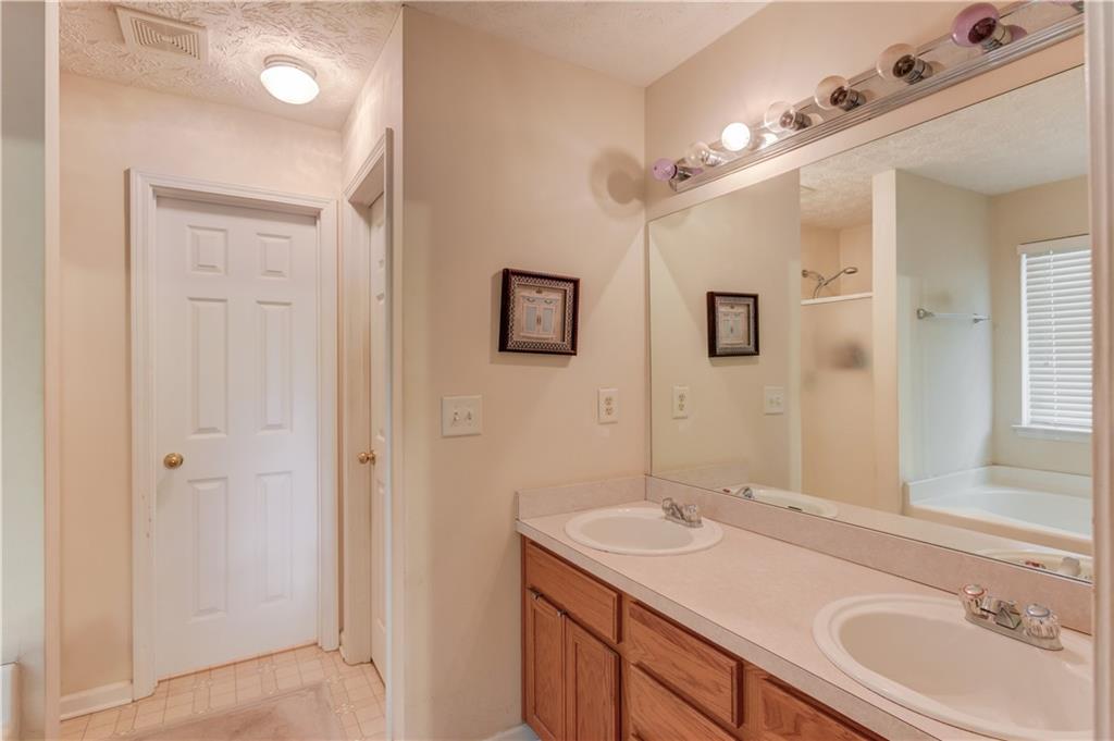 625 Springwood Trail Monroe, GA 30655 - Photo 9 of 23 a bathroom with a granite countertop sink and a mirror