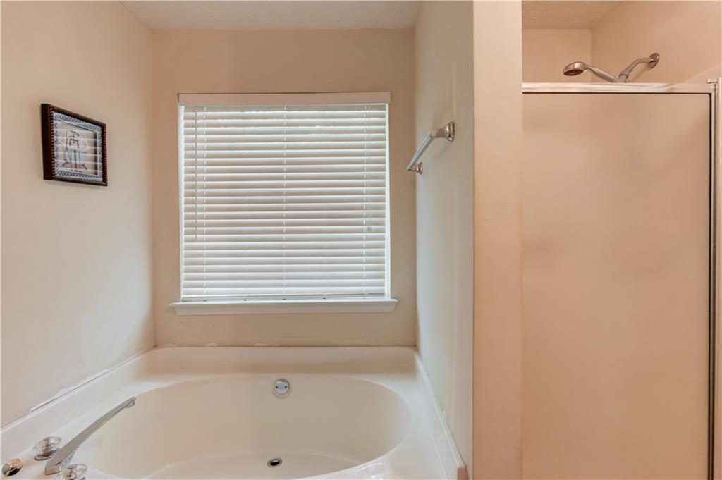 625 Springwood Trail Monroe, GA 30655 - Photo 10 of 23 a white bath tub sitting next to a window