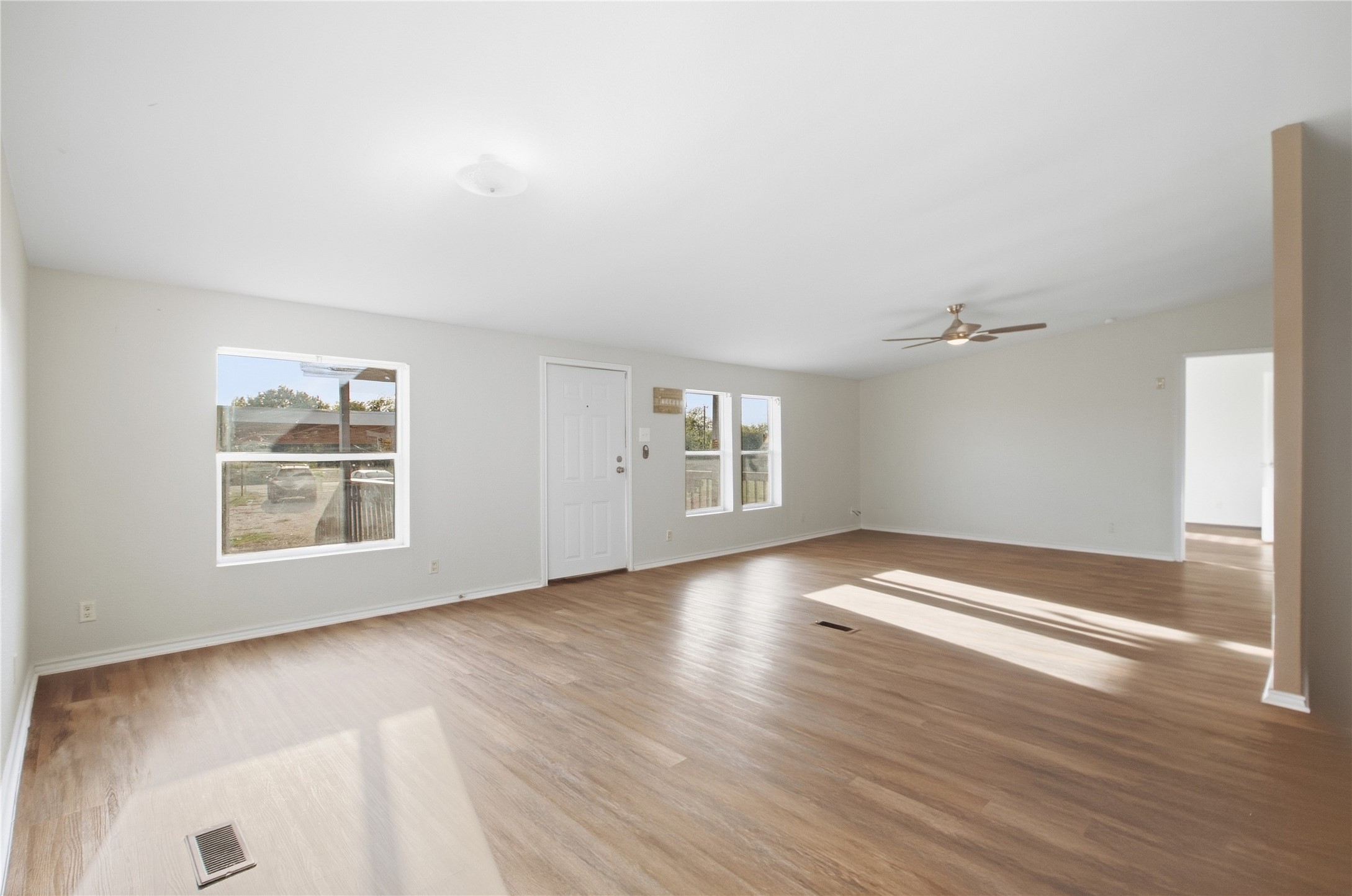 2709 County Road 463 Elgin, TX 78621 - Photo 18 of 32 Natural light streams across the extensive wood-look flooring of this spacious open living area.