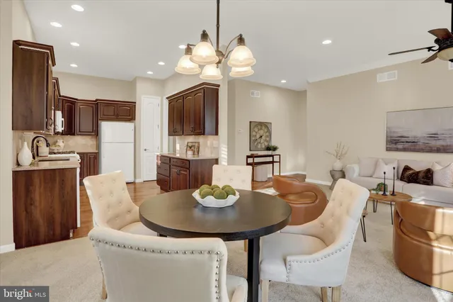 a dining room with furniture a chandelier and window
