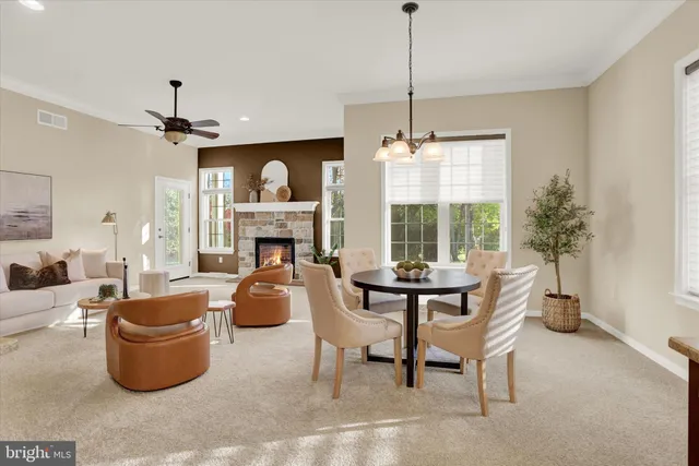 a dining room with furniture potted plants and wooden floor