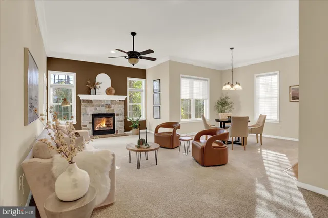 a living room with furniture a fireplace and a window