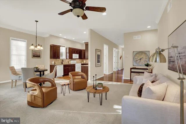 a living room with fireplace furniture and a chandelier