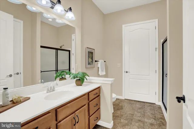 a bedroom with a bed and ceiling fan