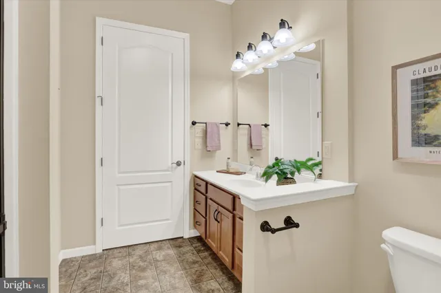 a bathroom with a sink a vanity and a mirror