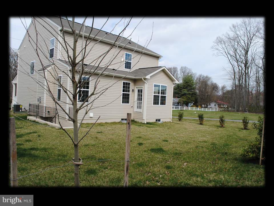 813 Wampler Road Baltimore, MD 21220 - Photo 5 of 30 a view of a big house with a big yard and large tree