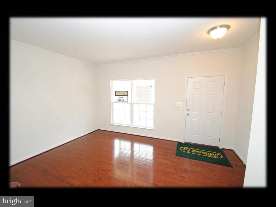 813 Wampler Road Baltimore, MD 21220 - Photo 10 of 30 a view of an empty room with wooden floor