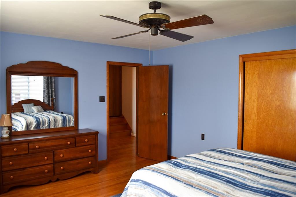 1149 Highland Avenue Vandergrift, PA 15690 - Photo 14 of 41 a bedroom with a bed and a chandelier